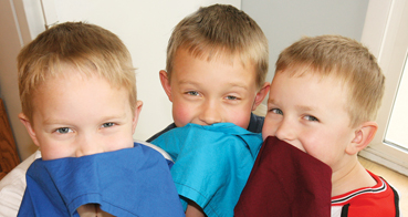 Christopher, Joshua and Jeffrey dust off crumbs with bright napkins especially for birthdays